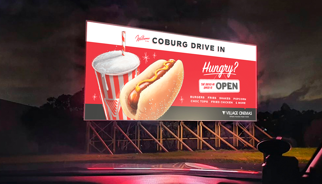 A drive-in cinema screen displays diner messaging.